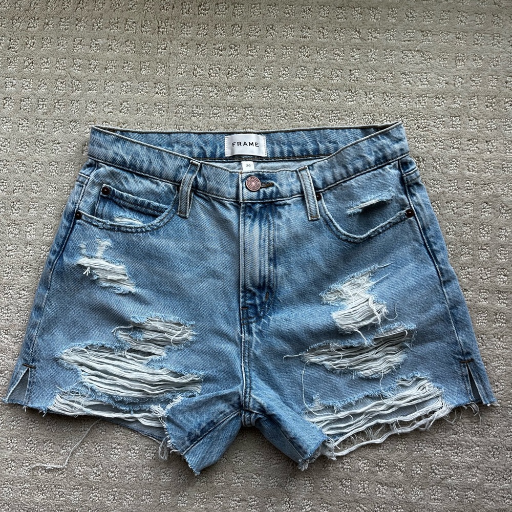FRAME light wash mid rise distressed shorts